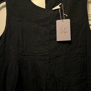 World of Crow black sleeveless pleated dress with side pocket
